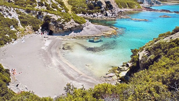A coastal landscape with a sandy beach, clear turquoise waters, and rocky outcrops. - Villa Gabriella "Sea View" (Upper Floor Apartment) (Santa Maria del Mare)