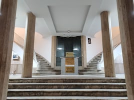 A grand staircase with marble steps leading to a reception area.