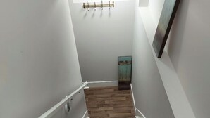 A staircase with white walls and wooden steps.