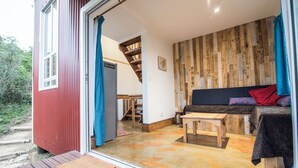 A cozy interior with a wooden wall, a sofa, and a small table.