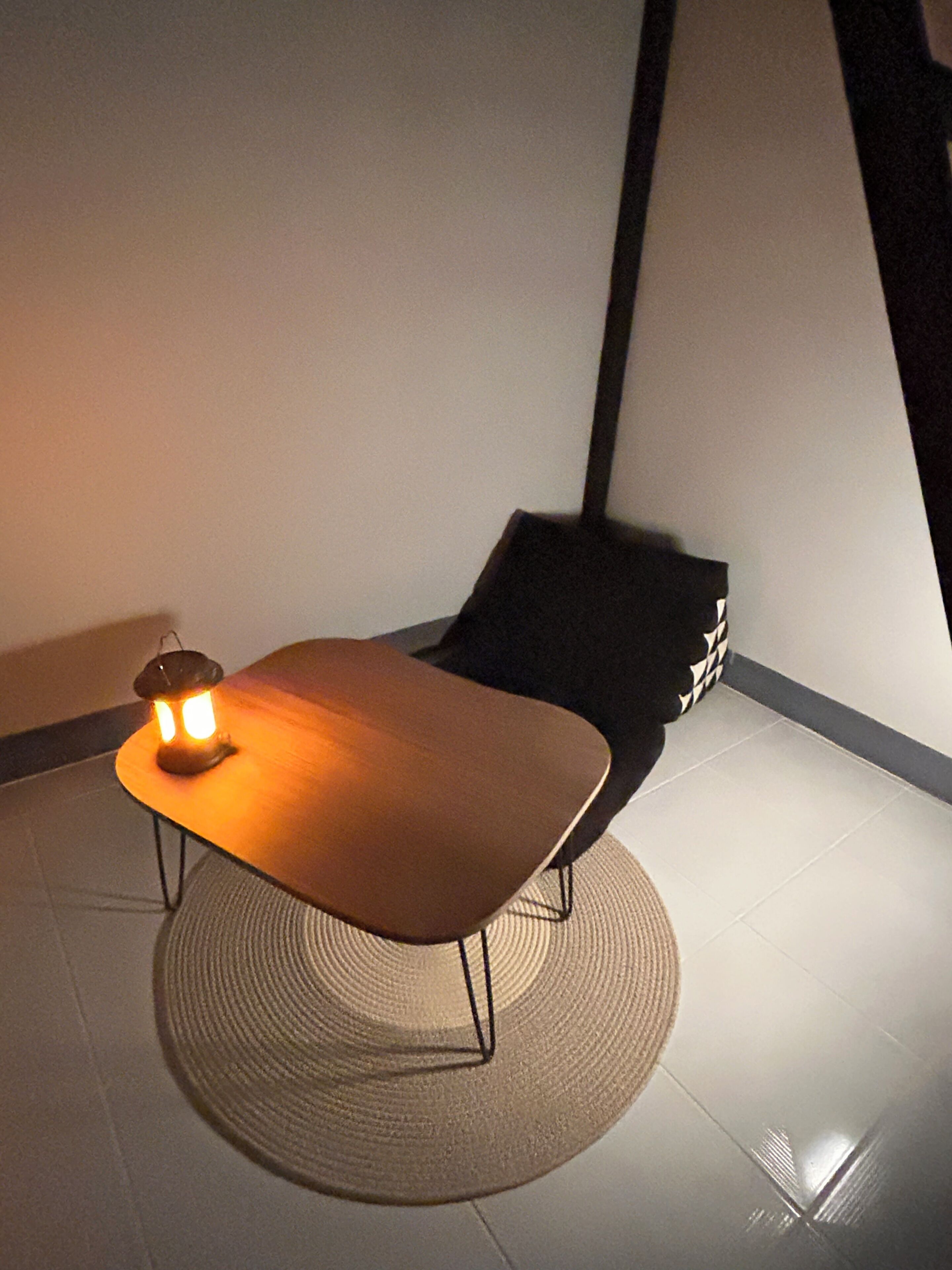 A small, modern room with a wooden table and a black chair.