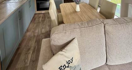 Welcoming family caravan on large pitch near beautiful New Quay in West Wales