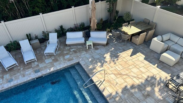 A backyard with a swimming pool, lounge chairs, a table, and a sofa. - Spacious Long Beach home, steps to beach & train (Long Beach)