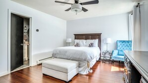 A bedroom with a bed, bedside tables, a chair, a ceiling fan, and a wardrobe. - Tenney Mountain Retreat, Plymouth & Rumney, NH (Plymouth)