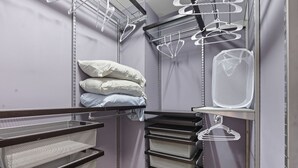 A storage closet with shelves, hanging organizers, and a metal rack. - Entire home in prime Raleigh with workspace, comm pool, dog park and golf course (Raleigh)