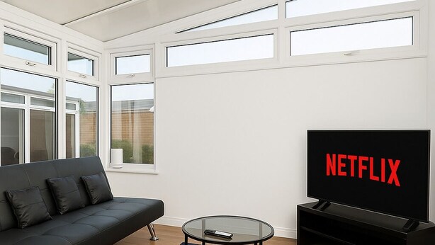 A modern living room with a black sofa, a glass coffee table, and a TV displaying the Netflix logo. - Prime 4BR Reading House & Free Parking (Reading)