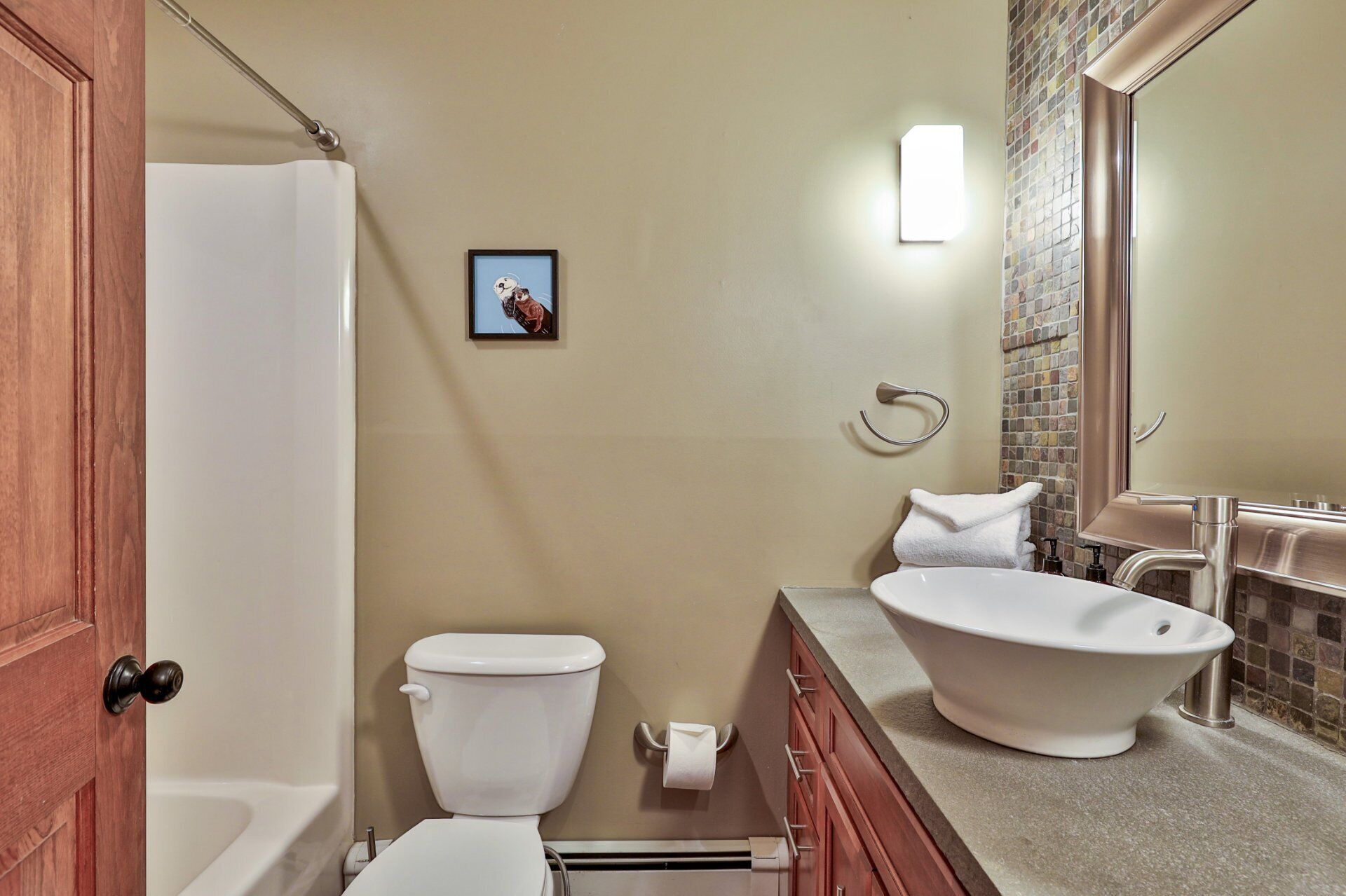 A bathroom with a toilet, sink, and shower.