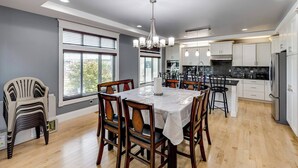 A modern kitchen with white cabinets, a black countertop, and a stainless steel refrigerator. - WATER FRONT PROPERTY WITH PRIVATE BOAT DOCK (Ferndale)