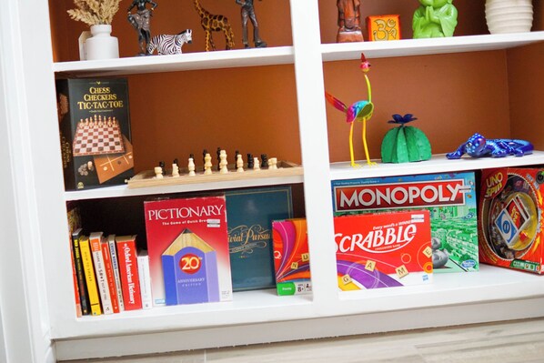 Een boekenplank met verschillende gezelschapsspellen en boeken.