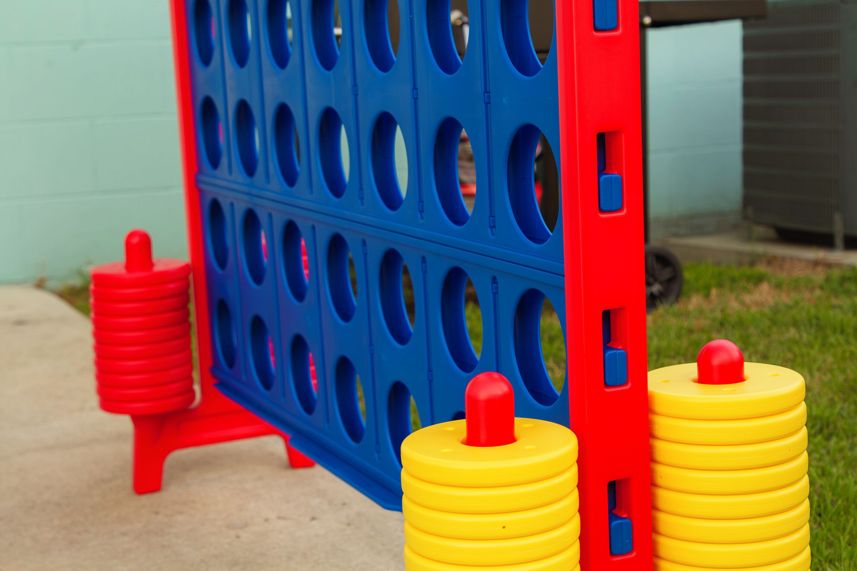 A blue and red play structure with yellow and red cylindrical objects.
