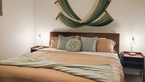 A neatly made bed with a green and beige striped blanket, two bedside lamps, and a wooden headboard. - Wellness Retreat • Sauna•Cold Plunge•Pool•Golf•Spa (Scottsdale)