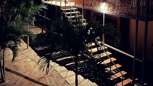 A modern house with a covered outdoor area, a staircase, and a balcony with a railing. - Elvis Surf Shack at Casa Akaw: a perfect retreat in a sustainable residence (Playa La Saladita)