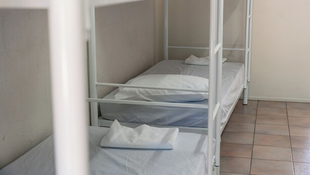 A bunk bed with white bedding and a tiled floor. - Freedom Backpackers Hostel (Rainbow Beach)