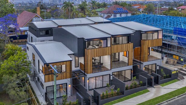 A modern multi-story house with a city skyline in the background. - Cozy Retreat with Modern Comforts (Entire place) (Camp Hill)