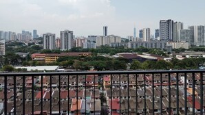 A cityscape with high-rise buildings and a densely packed residential area with red-roofed houses. - Corner unit 3R3B2cp condo, 550 sf terrace/balcony and AC in Kuala Lumpur (Kuala Lumpur)