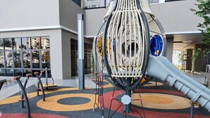 A playground with a slide and climbing structures, surrounded by a colorful circular play area. - Corner unit 3R3B2cp condo, 550 sf terrace/balcony and AC in Kuala Lumpur (Kuala Lumpur)