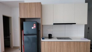 A modern kitchen with a built-in refrigerator, wooden cabinets, and a white countertop. - Corner unit 3R3B2cp condo, 550 sf terrace/balcony and AC in Kuala Lumpur (Kuala Lumpur)
