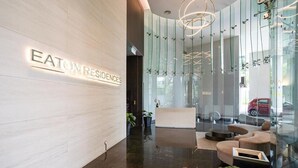 A modern reception area with a sign reading "EATON RESIDENCES".