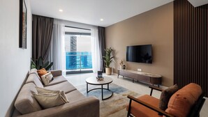 A modern living room with a sofa, coffee table, and TV.