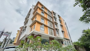 A multi-story hotel with a modern architectural design, featuring balconies and a prominent entrance sign. - Casa Lily Hotel Quezon City (Quezon City)