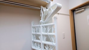 A wall-mounted drying rack with multiple clothespins. - Zenith Shinjuku Hinoki Building A (Tokyo)