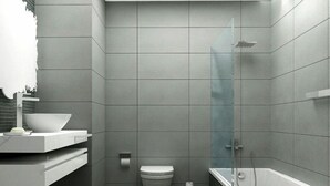 A modern bathroom with a shower, toilet, and a sink with a bowl. - Staybridge Suites DOHA LUSAIL by IHG (Lusail)