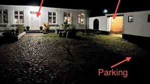 A building with an entrance, a key, and a parking area. - Apartment in rural idyll (Vamdrup)