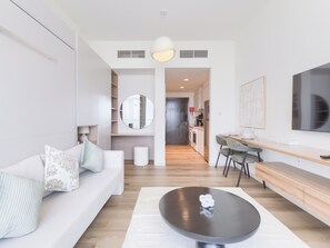 Deluxe Studio, Balcony, City View | Living area | 55-inch Smart TV with digital channels