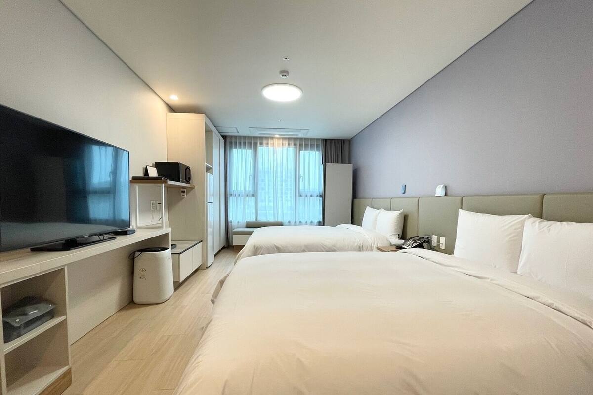 Family Twin Room, City View | In-room safe, laptop workspace, soundproofing, iron/ironing board