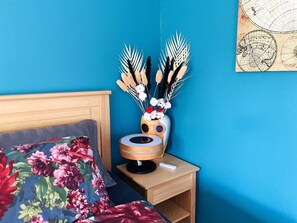 A room with a bed, a nightstand with a lamp, and a wall map. - 4 Star Holiday Home in Tvarred (Tvärred)