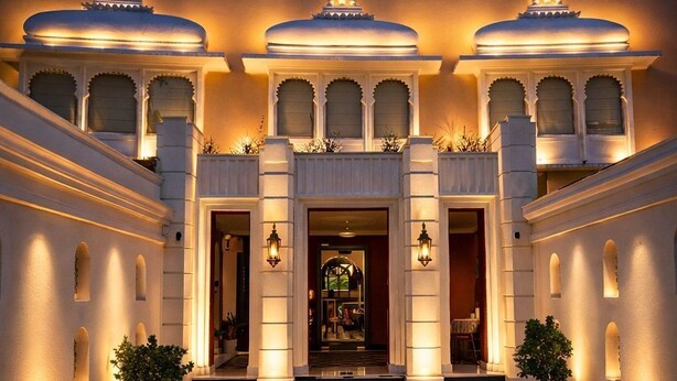 A grand entrance with a checkered floor, a central doorway, and three illuminated domes above. - Chandralok - A Boutique Hotel in Udaipur Near Fateh Sagar Lake (Udaipur)