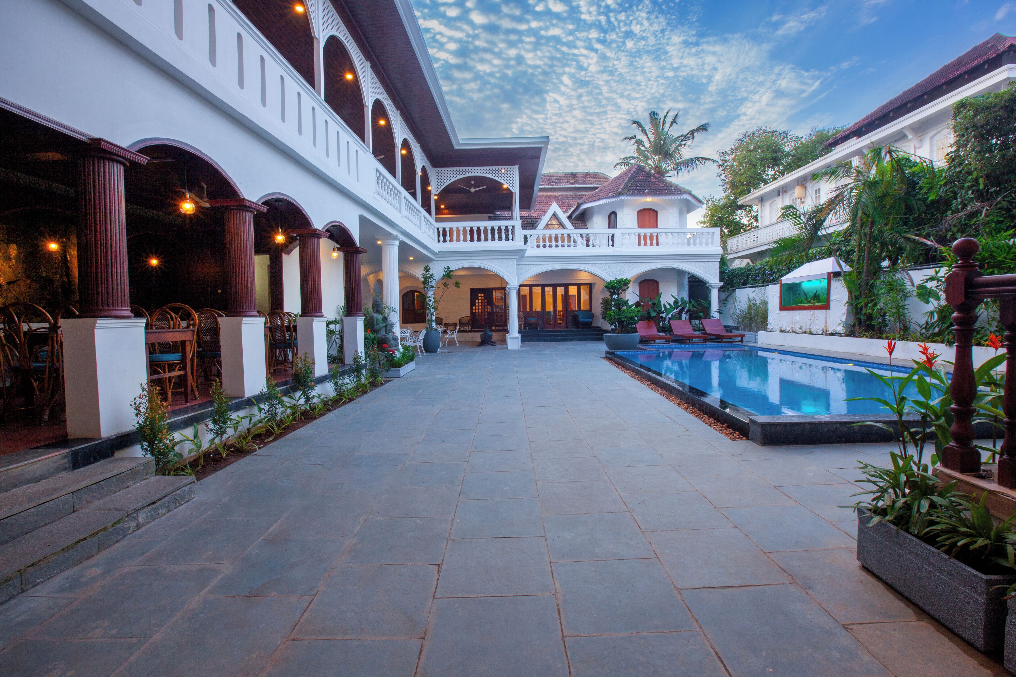 A courtyard with a pool, covered seating areas, and a central open space.