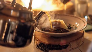 A close-up of a hot beverage being poured into a glass. - Ice and light village (Luleå)
