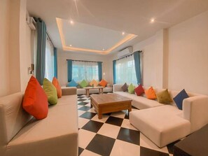 Grand Double Room, Balcony, Pool View | Living area | 35-inch TV with digital channels