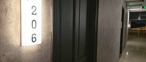 A hallway with a number sign '206' on the wall, indicating room number.