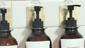 Three bottles of maisonnovo products: body wash, conditioner, and shampoo, each with a pump dispenser and a white label.