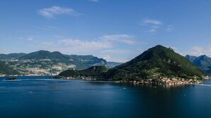 A mountainous island with a small settlement surrounded by a large body of water. - Pernice77 (Sulzano)