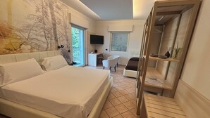 A modern bedroom with a large bed, a desk, a chair, and a small balcony. - Pernice77 (Sulzano)