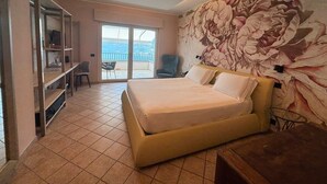 A bedroom with a bed, a desk, a chair, and a balcony with a view. - Pernice77 (Sulzano)
