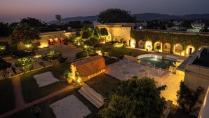 A courtyard with a pool, seating area, and a tent. - Medieval Forts, Kalwar, Jaipur (Jaipur)