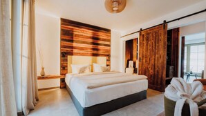 A bedroom with a bed, wooden panel wall, a sliding door, a bedside table, and a lamp. - WALDGUT Naturresort (Bad Gottleuba-Berggiesshuebel)