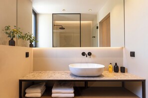 A modern bathroom with a large, round sink, a mirror, and a shower enclosure. - NEW 7- bedroom villa Ventana close to Dubrovnik Town, (Dubrovnik)