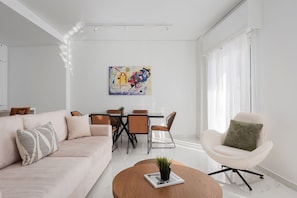 Deluxe Apartment, Balcony, City View | Living area | 50-inch Smart TV with satellite channels