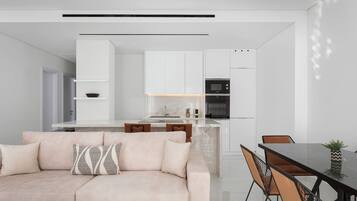 Deluxe Apartment, Balcony, City View | Living area | 50-inch Smart TV with satellite channels