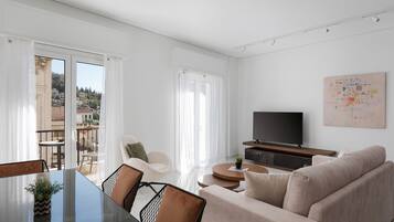 Deluxe Apartment, Balcony, City View | Living area | 50-inch Smart TV with satellite channels