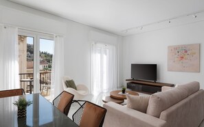 Deluxe Apartment, Balcony, City View | Living area | 50-inch Smart TV with satellite channels