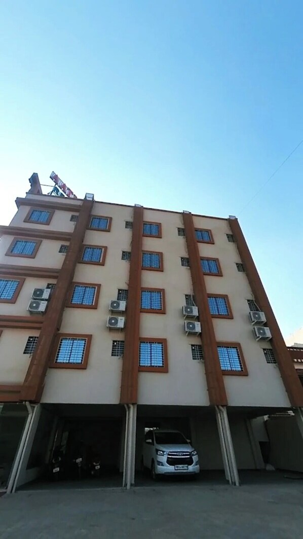 A multi-story building with a parking garage. - Aatithya Residency (Rajgurunagar)