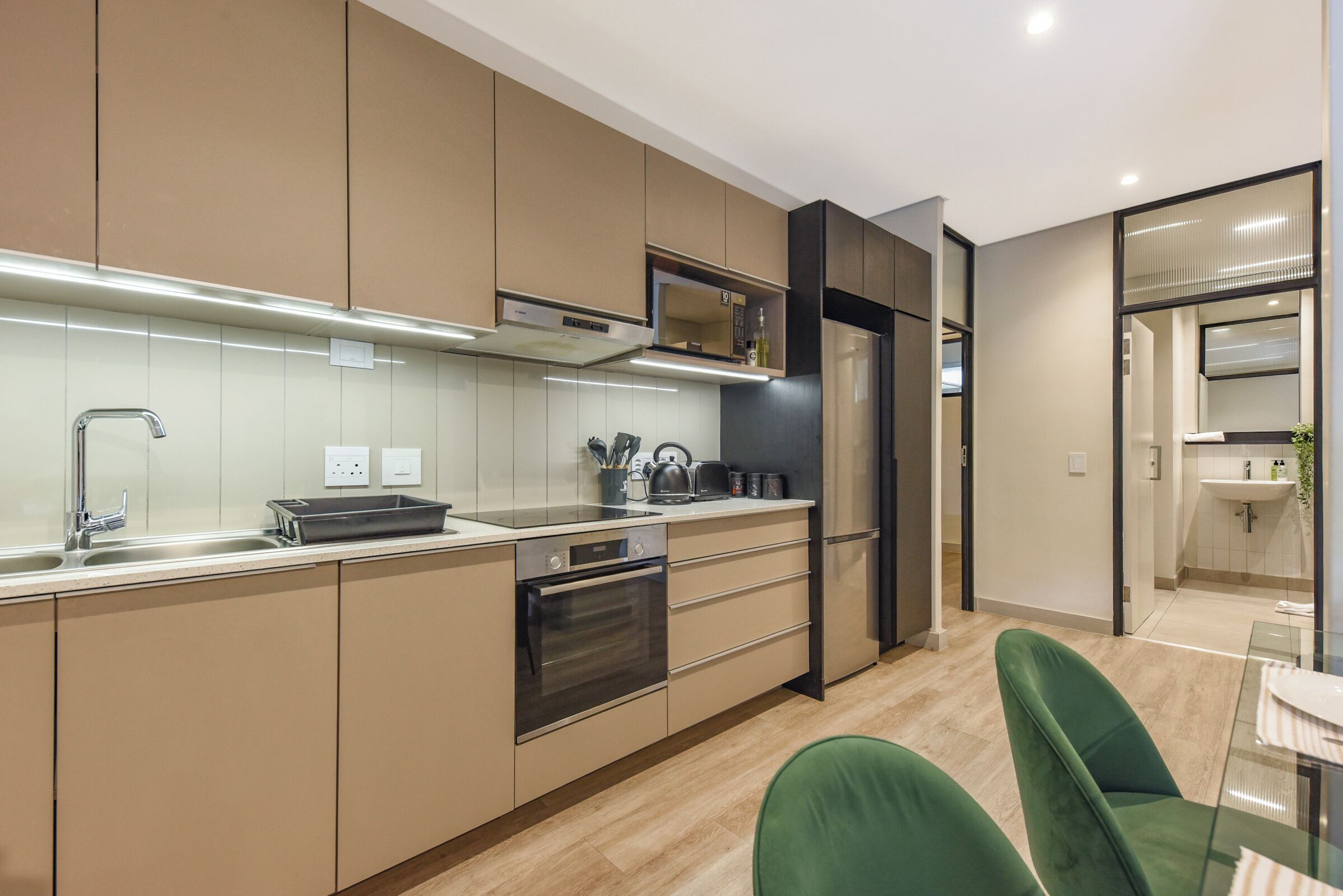 A modern kitchen with stainless steel appliances, a built-in oven, and a microwave.