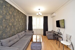 Economy Studio | Living area | 50-inch flat-screen TV with cable channels
