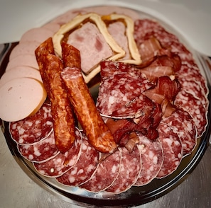 A platter of various cured meats and cheeses.